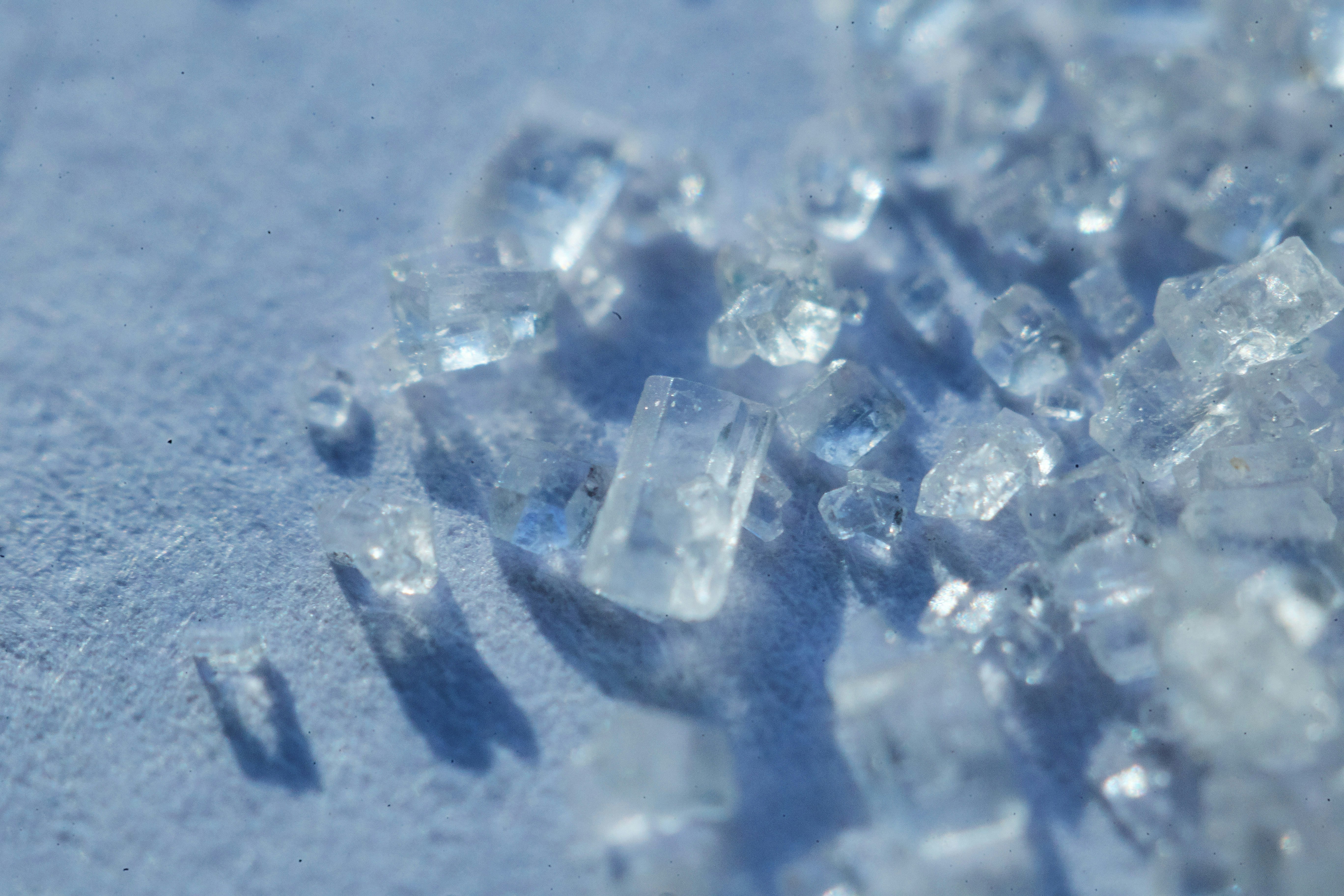 white and black crystal on white sand